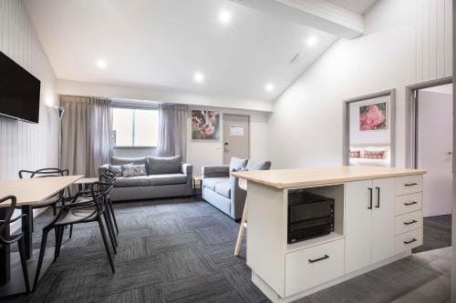 a living room with a couch and a table at Nightcap at Ferntree Gully Hotel Motel in Fern Tree Gully