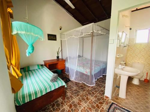 a bathroom with a bed and a sink in a room at Sabine Holiday Resort and Restaurant in Matara