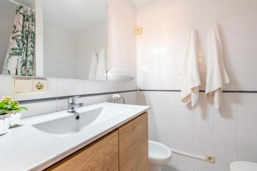 a white bathroom with a sink and a toilet at Can Vidal Ibiza in Ses Salines