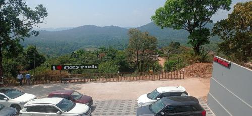 a group of cars parked in a parking lot at Dreams River view home stay coorg 2 in Kushālnagar