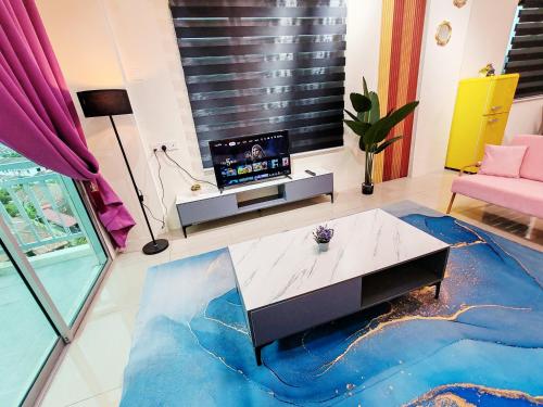 a living room with a tv and a table at Pavilionvillie M1T692 by irainbow in Ipoh