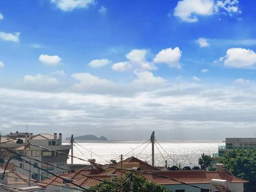 a view of the ocean from a city with buildings at Machico center w/ terrace 5 min beach in Machico