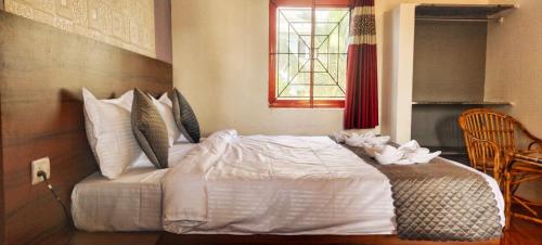 a bedroom with a white bed with flowers on it at Calangute Beach Front in Calangute