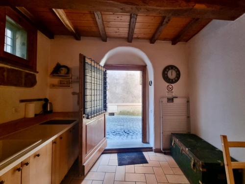 a kitchen with an open door to a pool at Francigena Maison in Sutri