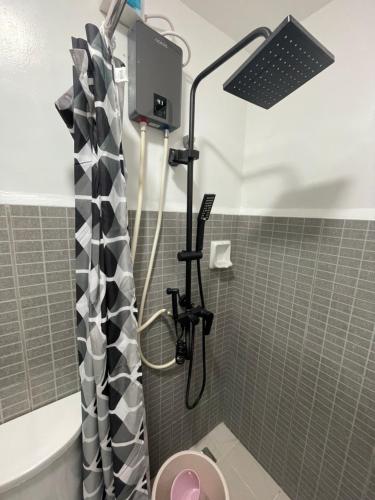 a bathroom with a shower with a toilet at Studio Anna in Cebu City