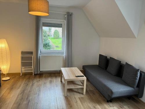 a living room with a couch and a table at Ferienhaus Dierdorf in Dierdorf