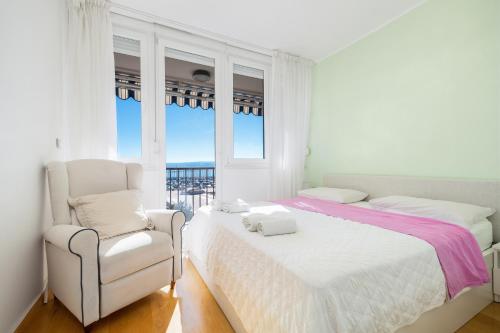 a white bedroom with a bed and a chair at Luxury residence Adriatic Pearl in Split