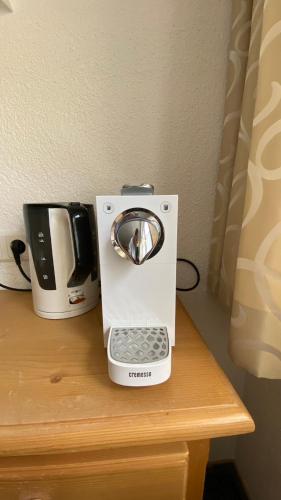 a coffee maker and a toaster sitting on a table at Zimmer Enzian in Längenfeld