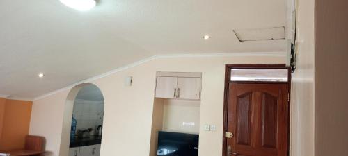 a room with a hallway with a door and a ceiling at One bedroom panthehouse in Kisumu