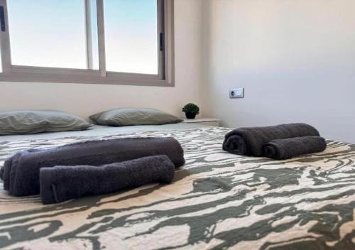 a bedroom with a bed with pillows on it at Nuevo apartamento en Sant Carles de la Ràpita in Sant Carles de la Ràpita