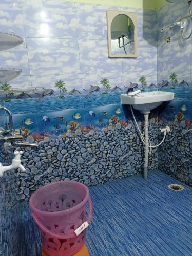 a bathroom with a sink and a rock wall at Dreams River view home stay coorg 2 in Kushālnagar