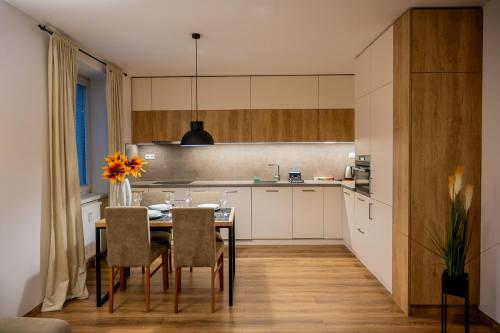 a kitchen with a table and chairs in a room at Old Town city center apartment 1 - private parking included in Košice