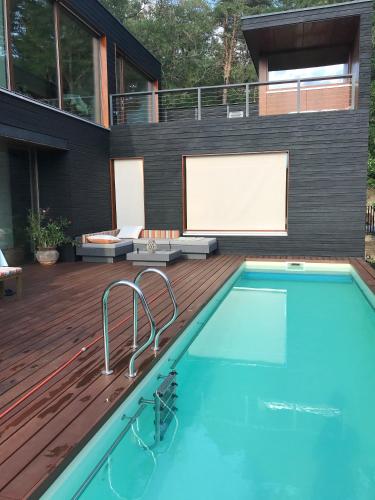 a house with a swimming pool and a deck at Ferienwohnung am Einsteinhaus Caputh in Caputh