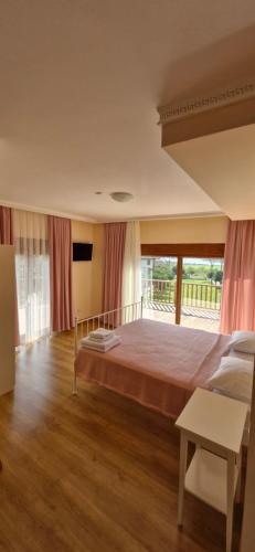 a bedroom with a large bed and a large window at Villa Bianca in Muğla