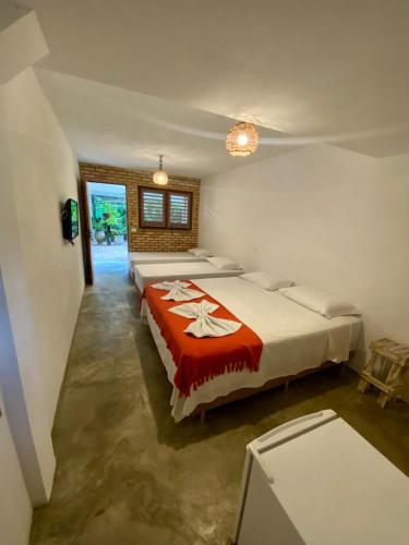 a bedroom with two beds in a room at POUSADA TAIEIRAS in Maragogi