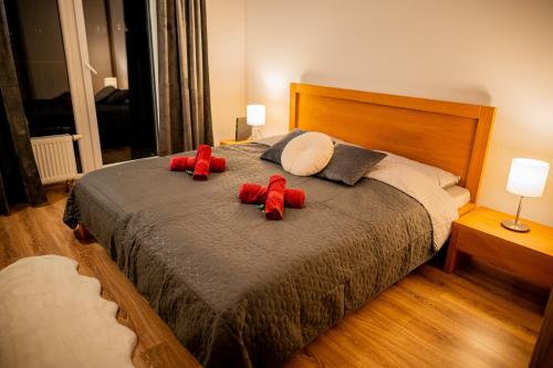 two red teddy bears are sitting on a bed at Old Town city center apartment 1 - private parking included in Košice