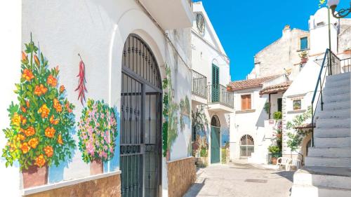 een gebouw met een deur met bloemen erop bij Nonna Elena in Rodi Garganico