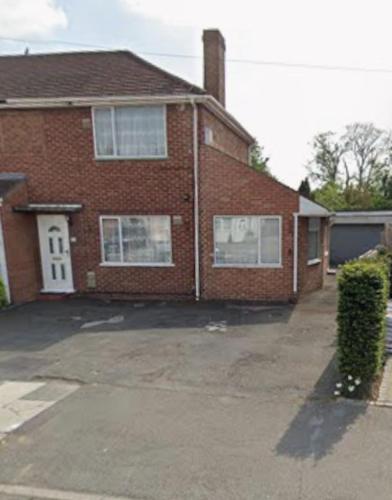a brick house with a driveway in front of it at 39 Sri Gandha in New Bedfont