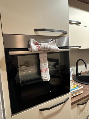 a kitchen with an oven with a towel hanging from it at Vila Drina Apartments in Banja Koviljača