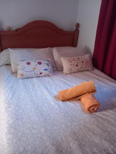 a bed with a towel and pillows on it at Casa rural entre la naturaleza Gomera in El Cercado