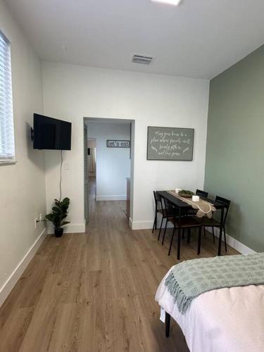a room with a table and a chalkboard on the wall at Miami Coral Gables Studio near Airport and Beaches in Miami