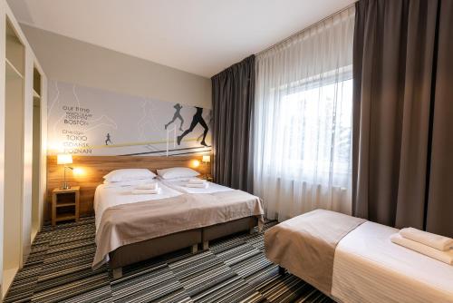 Postel nebo postele na pokoji v ubytování Hotel Maraton