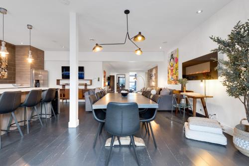 a dining room and living room with a table and chairs at LiV MTL Plato in Montréal