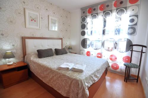 een slaapkamer met een bed met twee handdoeken erop bij RNET - 221 Porto Marina Roses Costa Brava in Roses