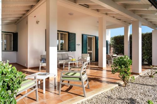 a patio with chairs and a table and chairs at Dimore Anny in San Lorenzo