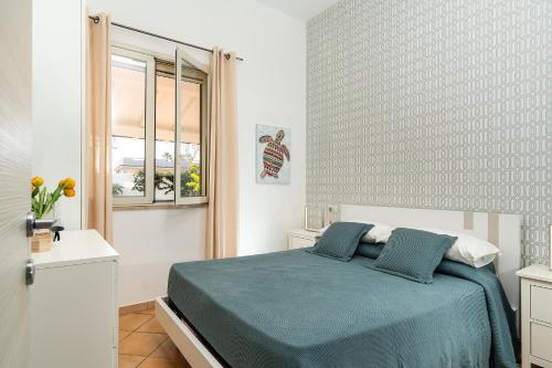 a bedroom with a bed and a window at Dimore Anny in San Lorenzo