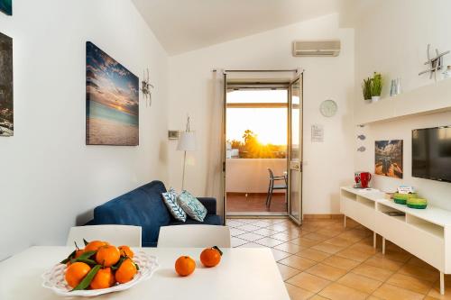 a living room with a table with oranges on it at Dimore Anny in San Lorenzo