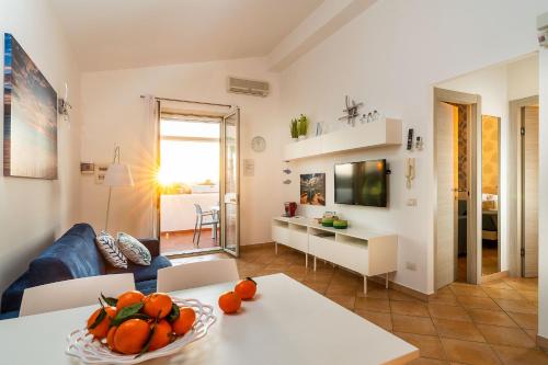 a living room with a couch and a table with oranges at Dimore Anny in San Lorenzo
