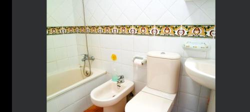 La salle de bains est pourvue de toilettes, d'un lavabo et d'une baignoire. dans l'établissement Primera línea de playa en Canela Park, à Isla Canela