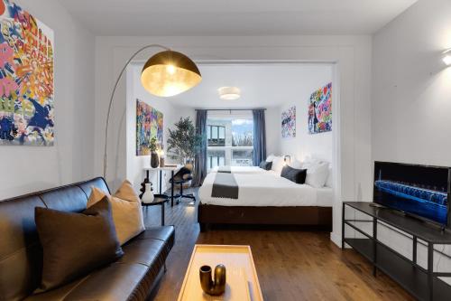 a living room with a bed and a couch at LiV MTL Avenue in Montréal