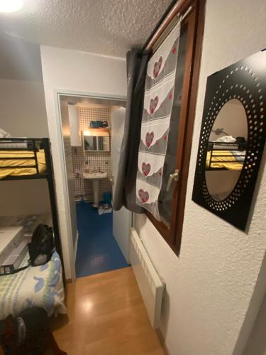 a hallway with a room with a bed and a mirror at Bouffée d’oxygène in Uvernet