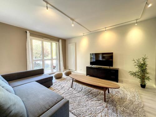 a living room with a couch and a coffee table at Hamac Suites - Docteur Terver - 6 people in Écully