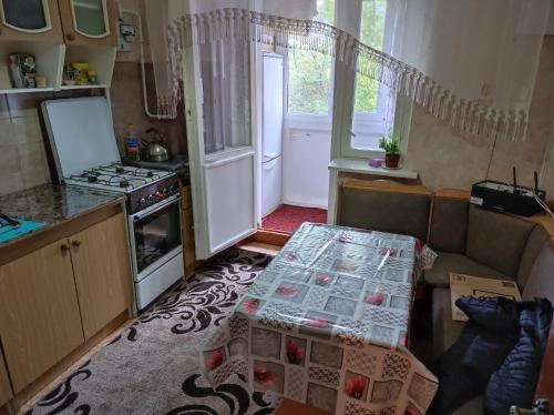 a small kitchen with a table and a stove at Hotels in Orhei