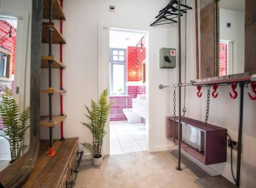 a room with a hallway with a mirror and a door at Central Townhouse With Roof Terrace in Manchester