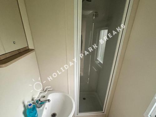 a bathroom with a shower next to a sink at Cosy 2 bed @ Seal Bay, Selsey in Selsey