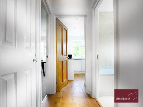 a hallway with a yellow door in a white room at Sunninghill Village - 2 Bed - Parking and garden in Ascot