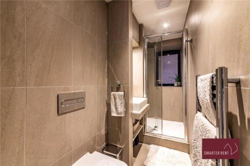 a bathroom with a toilet and a sink at Wooburn Green - Modern One Bedroom Apartment in Bourne End