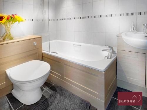 a bathroom with a toilet and a sink at Bisley - 2 Bedroom House - Front Garden and Parking in Bisley
