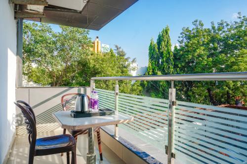 a table on a balcony with a tea kettle on it at FabExpress Tulsi Park - Nr Sai Baba Temple in Shirdi