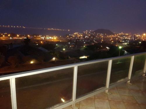 a view of a city at night from a balcony at Albatros Nes 49 Van Spilberg Road Saldanha in Saldanha