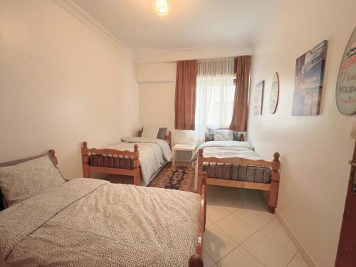 - une chambre avec deux lits et un canapé dans l'établissement Appart central avec terrasse, à Tanger