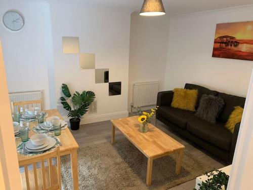 a living room with a couch and a table at Luxury 2 Bedroom apartment in King's Cross in London