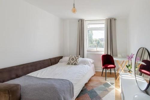 a living room with a couch and a window at Central London Stylish Flat with Terrace in London