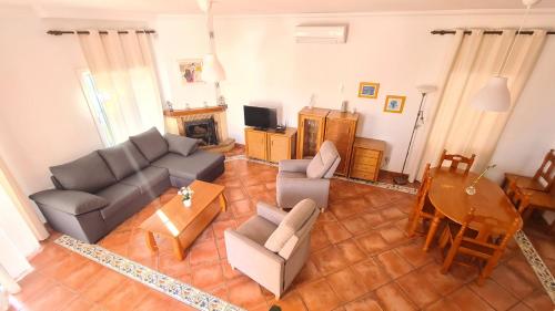 a living room with a couch and a table at Nerja Villas Tamango Hill Silhouse in Nerja