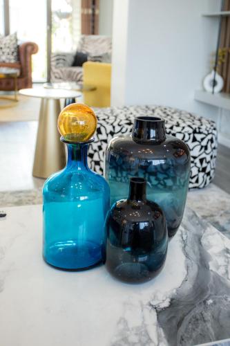 three blue glass vases sitting on a table at Blue View B&B in East London