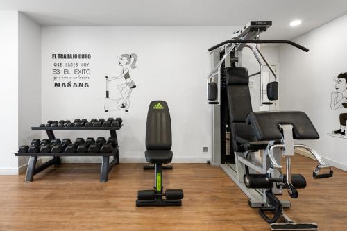 a gym with exercise equipment in a room at Sensation Sagrada Familia in Barcelona